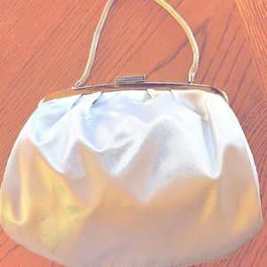 A Prague creme colored satin evening bag.